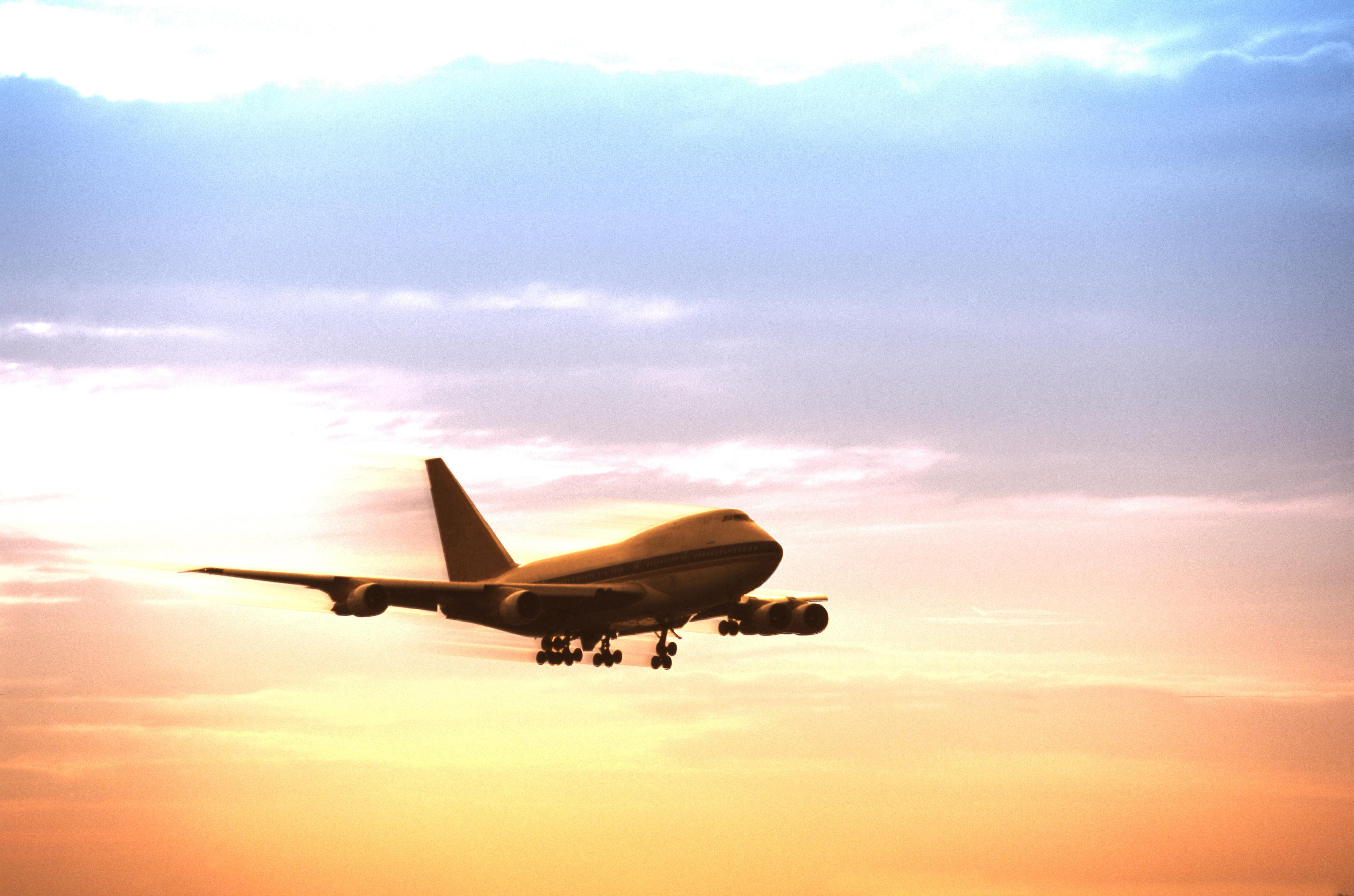 Airplane in flight at dusk