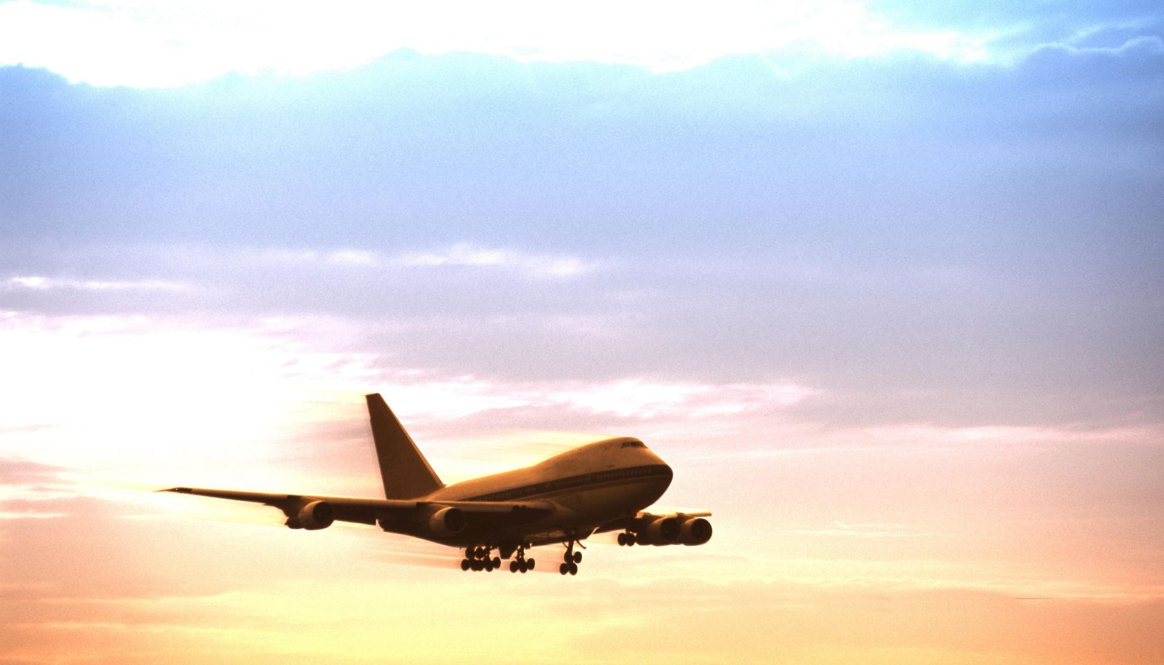 Airplane in flight at dusk