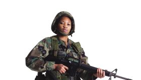 a young african american female soldier stand in fatighues with her gun