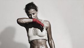 Female Boxer wiping off the sweat from her face
