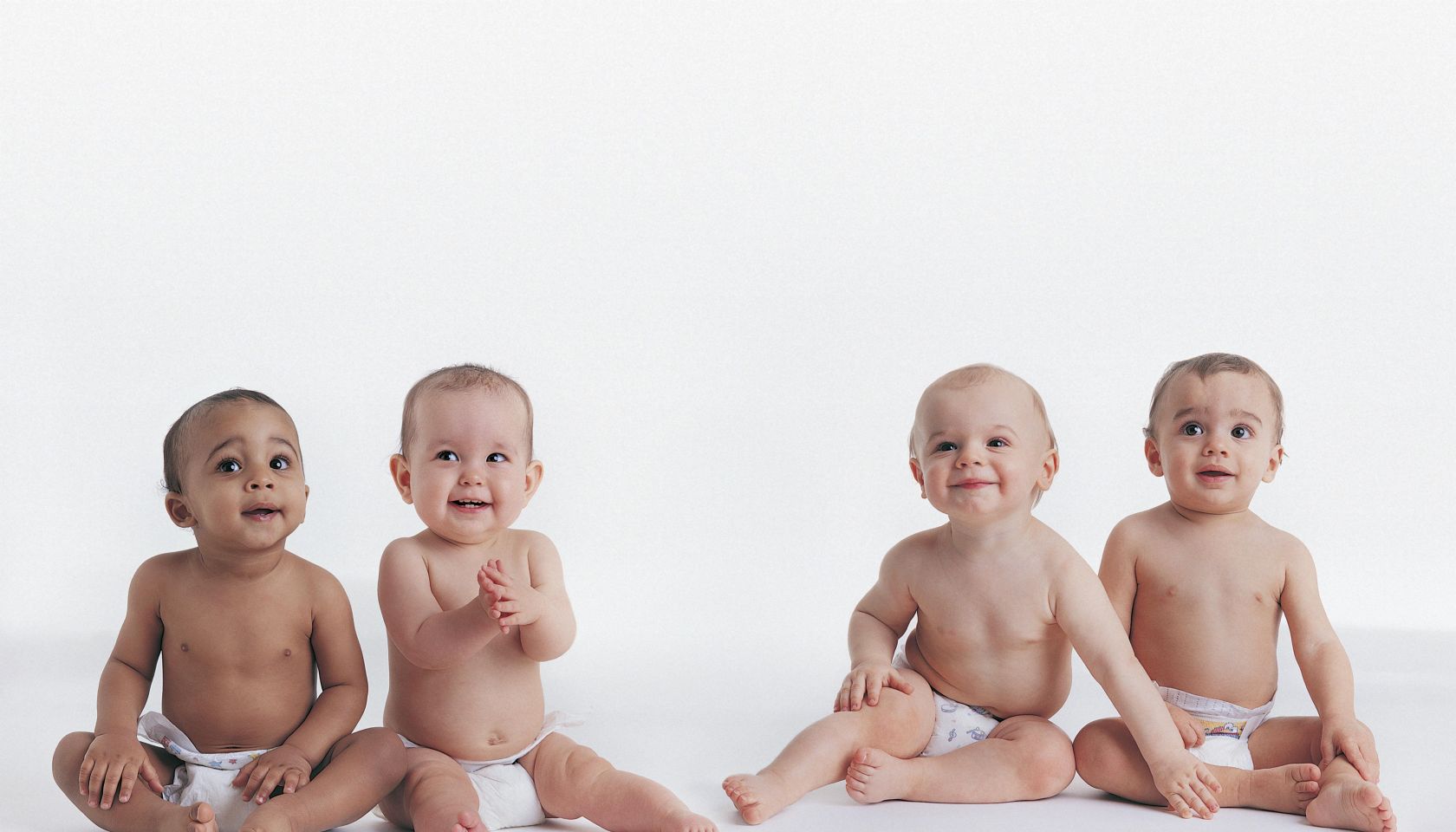 Portrait of Four Babies Sitting in Their Nappies