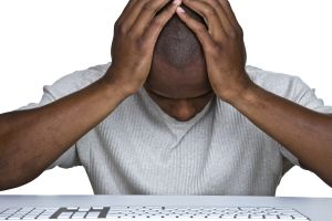 Discouraged man sitting in front of a computer