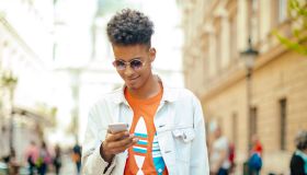 Young man using phone in the city
