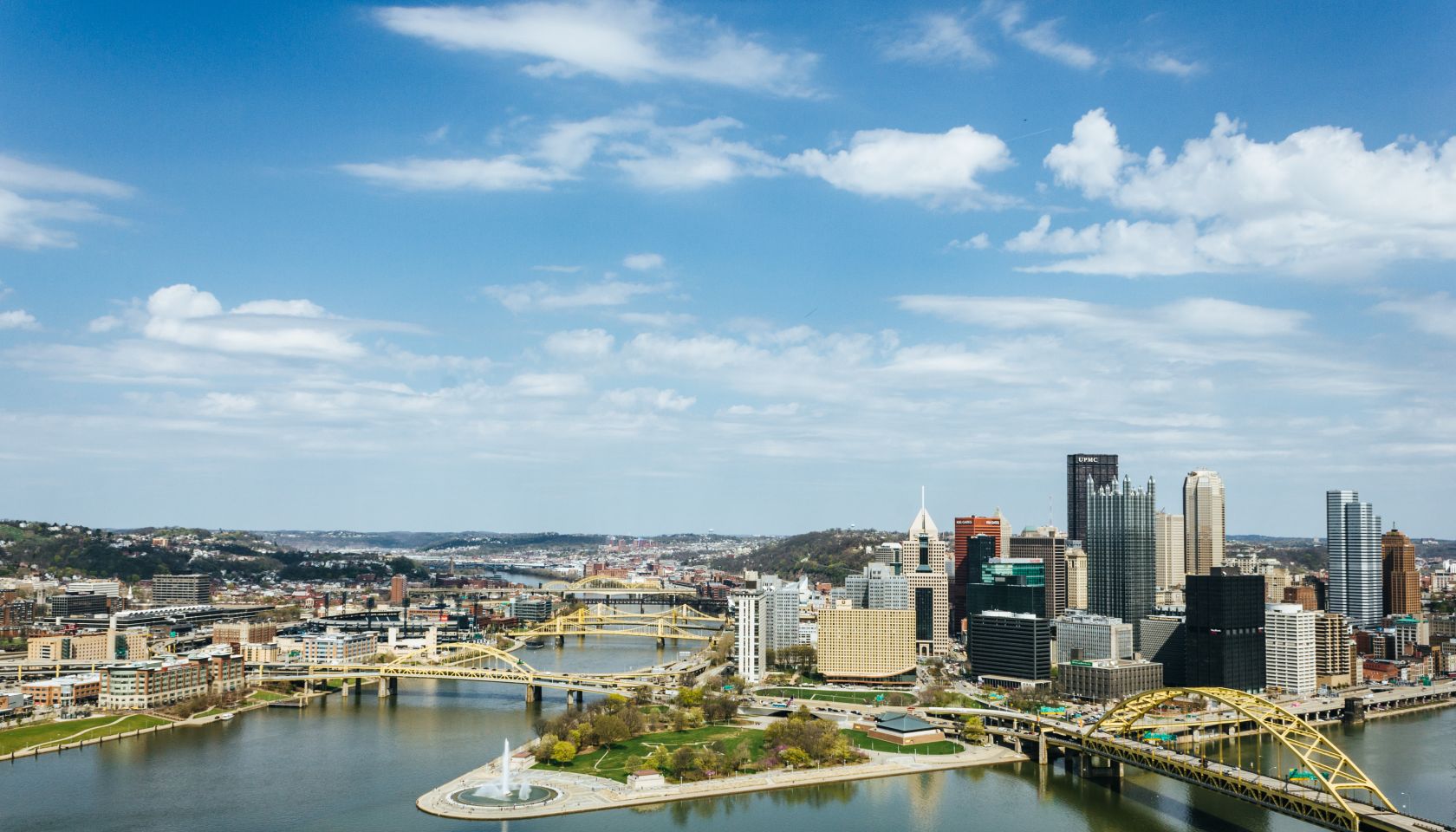River Amidst Buildings In City Against Sky