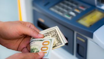 Cropped Hands Of Person Removing Cash From Atm Machine