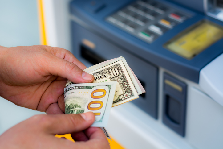 Cropped Hands Of Person Removing Cash From Atm Machine