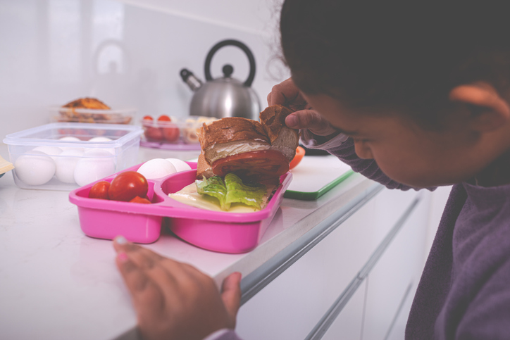 Girl checking her lunch box.