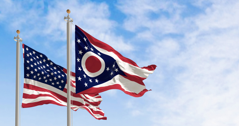 The Ohio state flag waving along with the national flag of the US