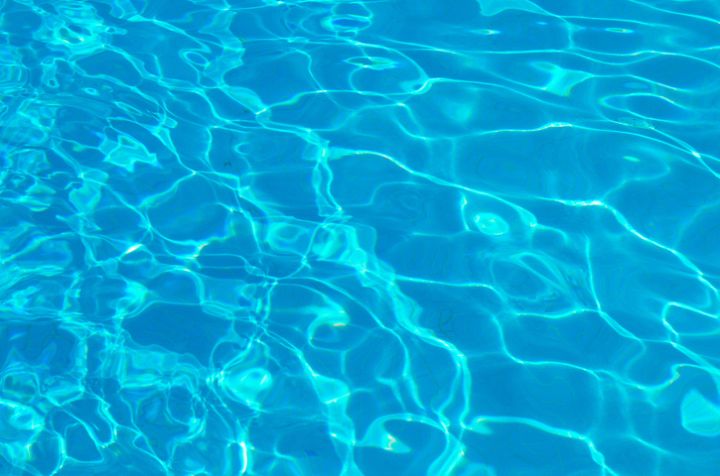 Abstract Background. Deep, blue, shimmering pool Water from a high angle, taken from above or overhead.