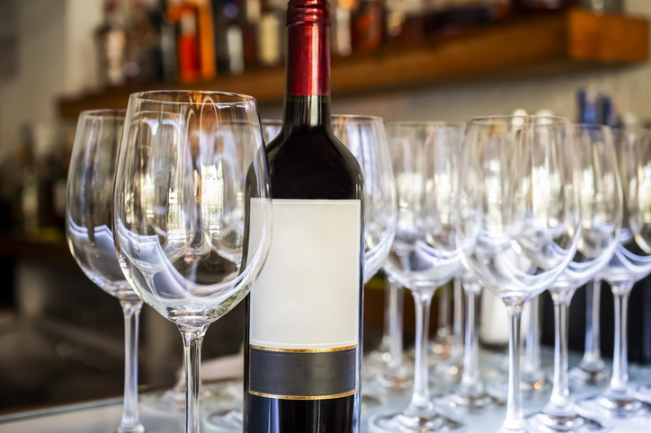 Red Wine Bottle and Empty Wine Glasses on Bar Counter