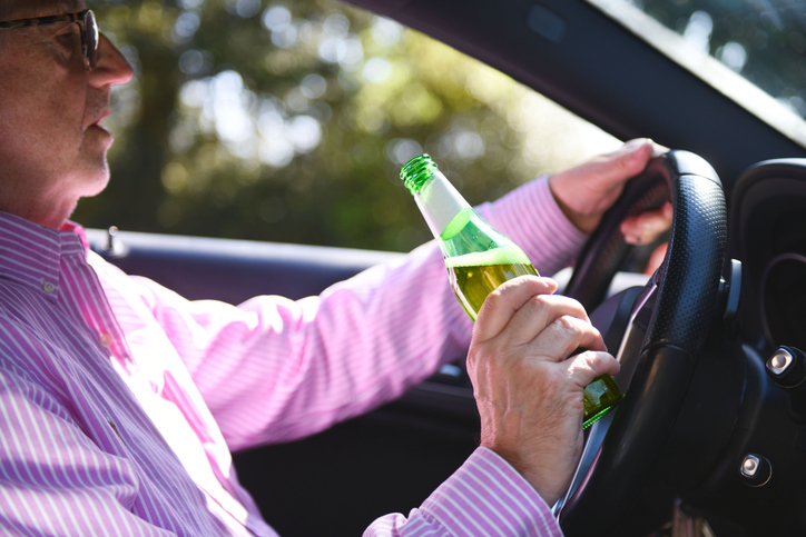 Left hand driving and drinking.