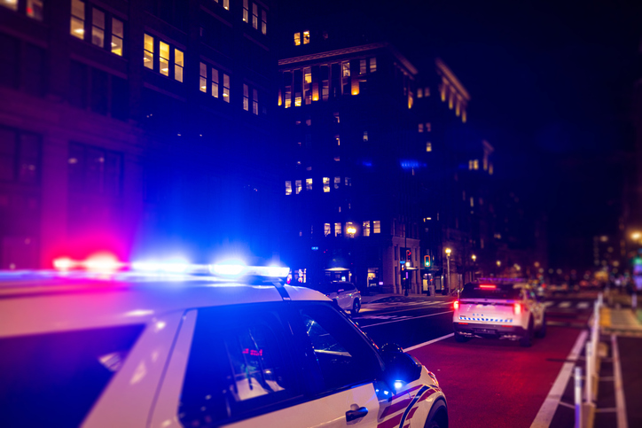 Police Car with Lights on at night in City