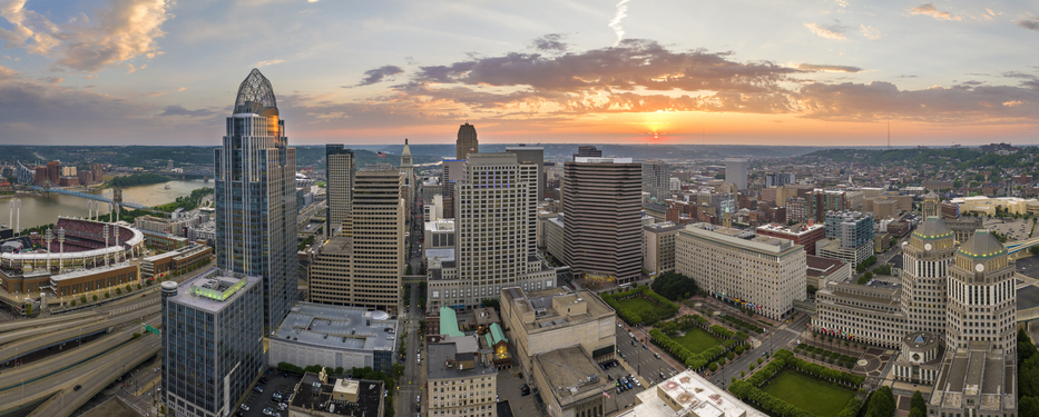 Downtown district of Cincinnati in Ohio, USA at sunset with brightly illuminated high skyscraper buildings. American travel destination
