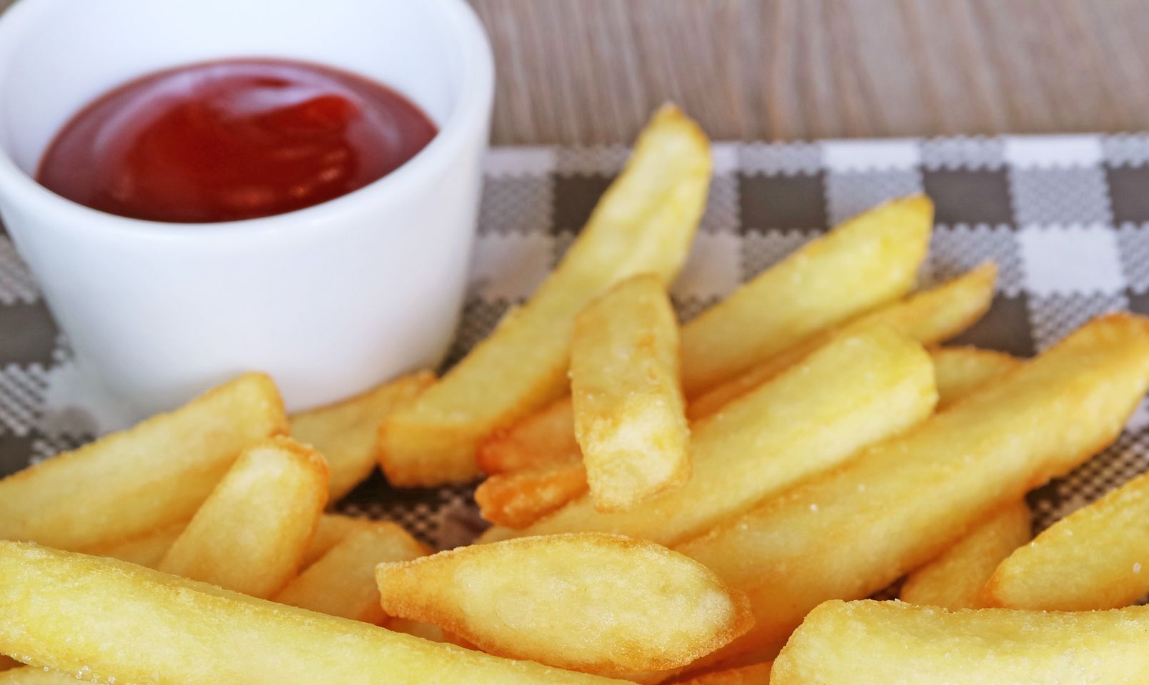 Pile of delectable crispy French fries with flavorful ketchup