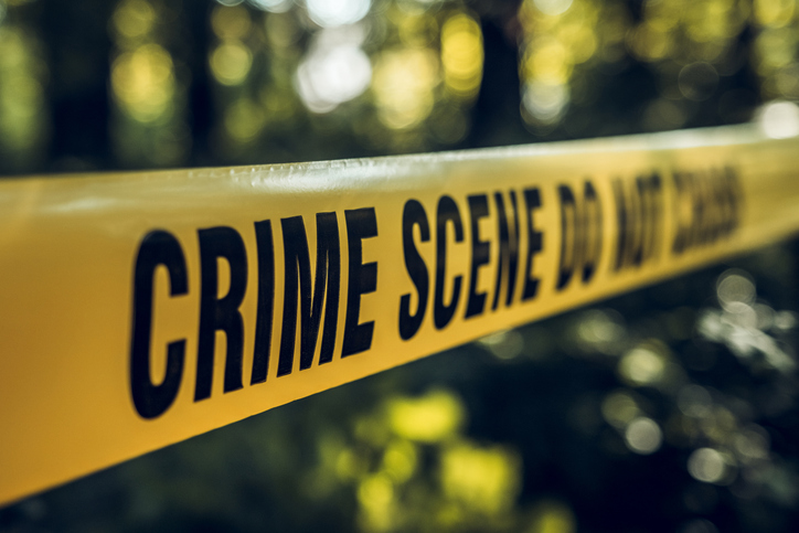 Crime scene tape in forest area