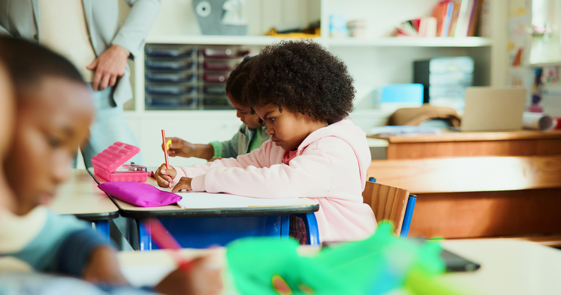 Education, kid and writing in classroom for learning, lesson and creativity with stationery. Child, notebook and drawing in elementary school for development, growth and cognitive thinking in profile