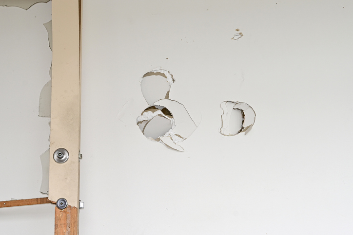 Holes punched in a plaster wall