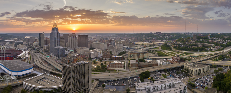 Urban landscape USA. Downtown district of Cincinnati in Ohio state in evening. American city skyline with brightly illuminated high commercial buildings