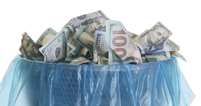 Trash bin with dollar banknotes isolated on white