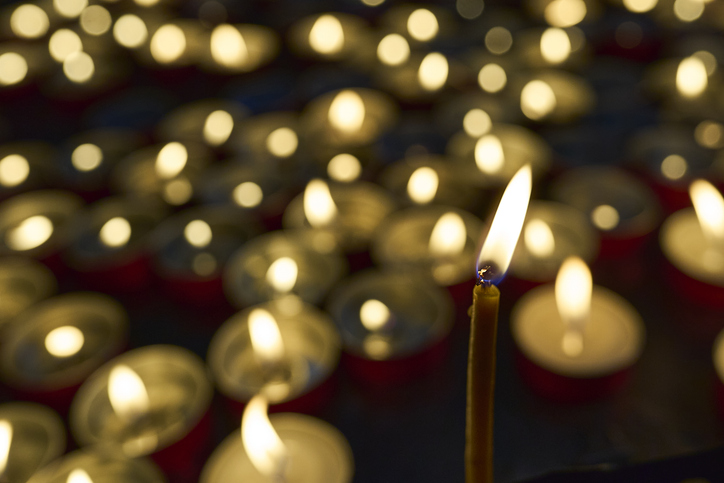 Church memorial prayer flickering golden light candles
