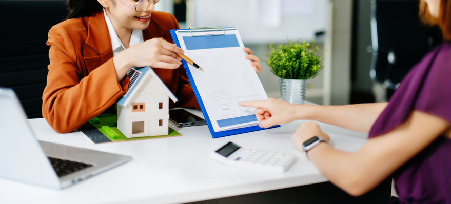 Salesman Hands On House Model , Small Toy House Small Mortgage Property insurance and concepts real estate