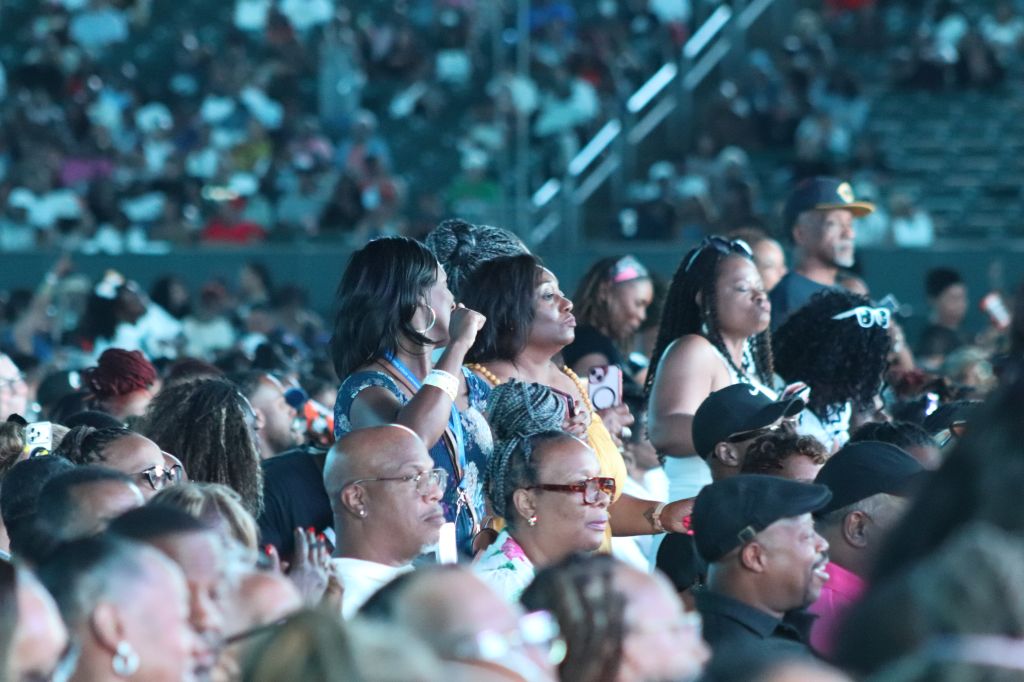 A large crowd of people attending an event or concert, with many individuals visible in the audience.