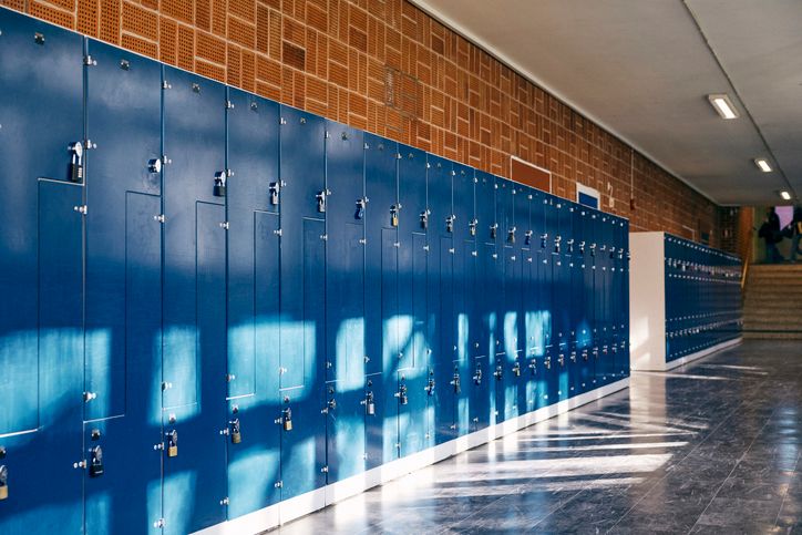 Blue lockers in empty junior high school lobby